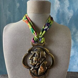 Vintage-Inspired Brass Pendant Necklace with Bright Floral Scarf